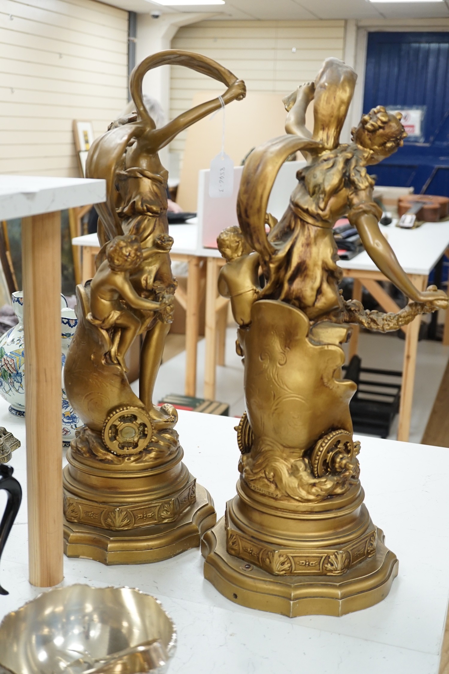 A pair of gilt spelter groups of a classical maiden and cherub, 61cm tall